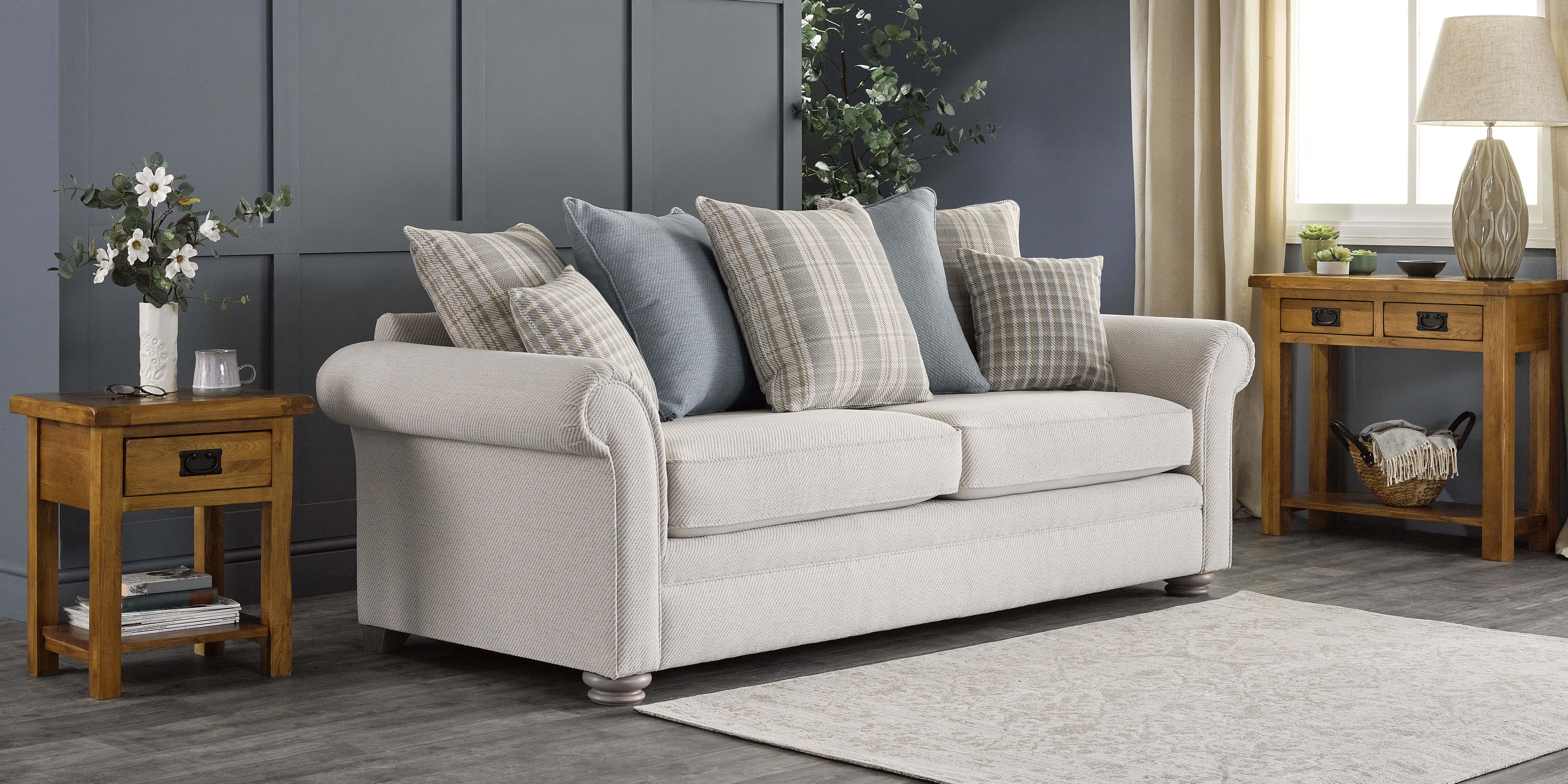 Beige sofa and natural oak furniture in blue and grey living room